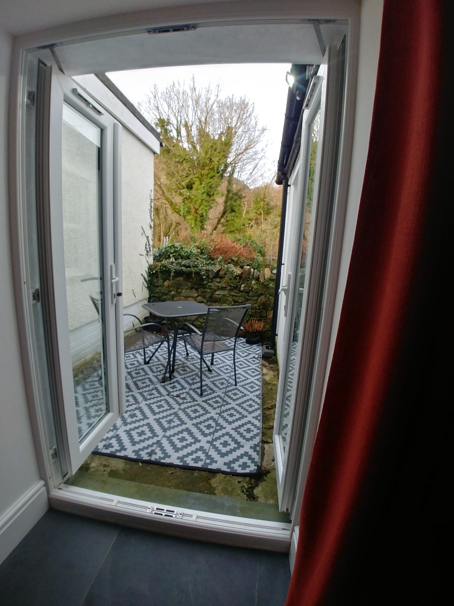 French doors from dining room to sheltered seating area