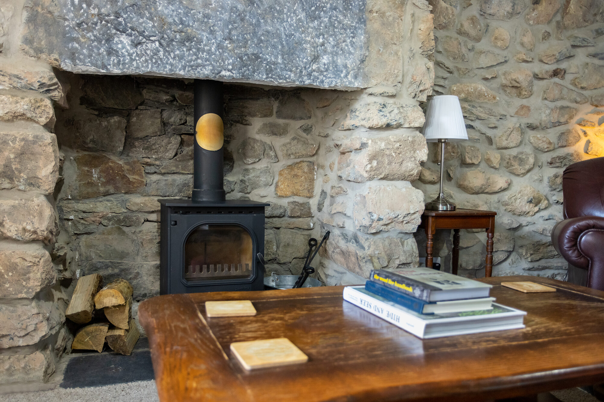 Log burner set in stone fireplace