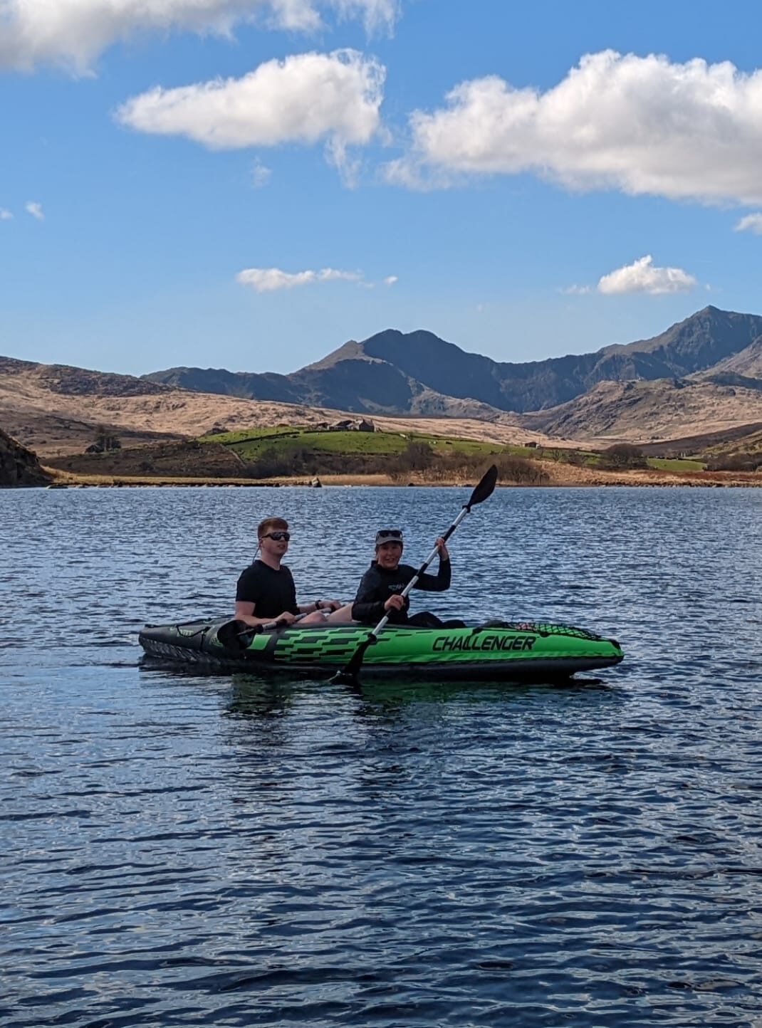 Woman and boy kayaking on llynau mymbyr