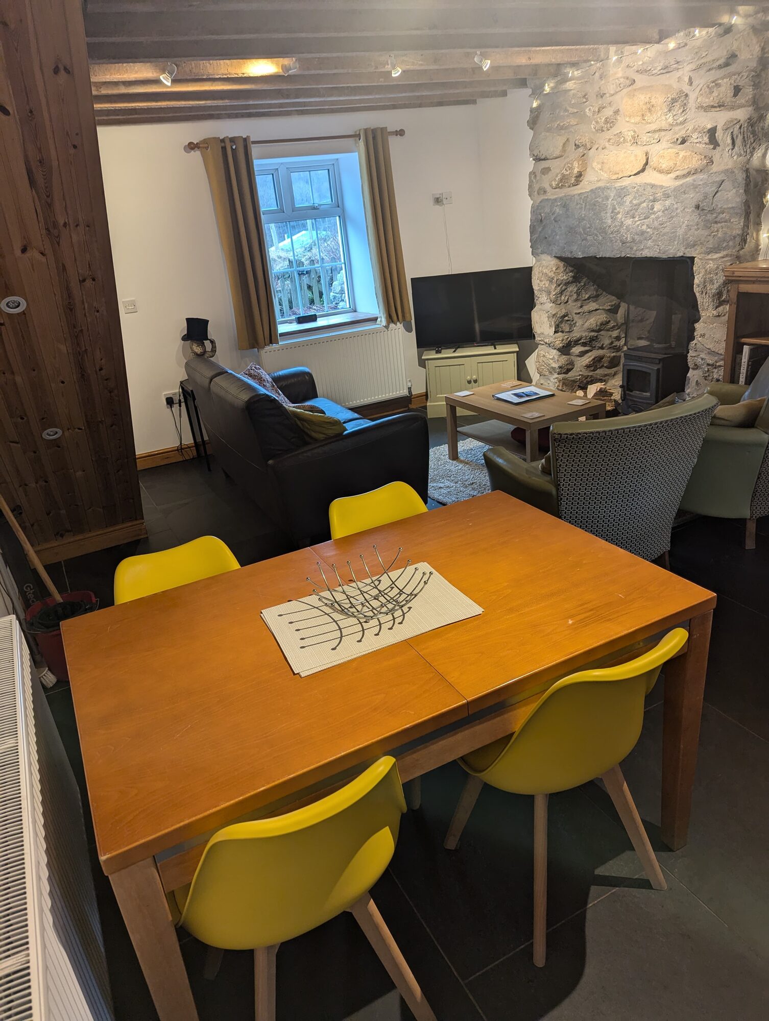 Open plan dining table with view into lounge