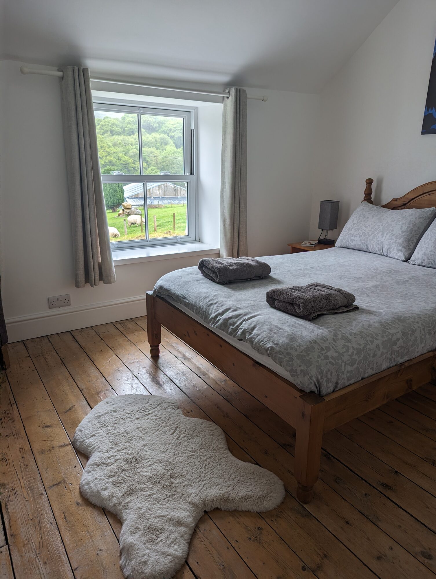 Bright double bedroom with pine bed